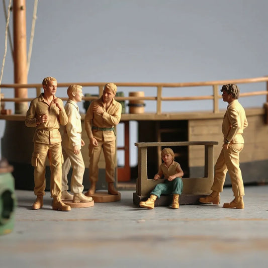 Scale crew model figures posed on a miniature ship deck for a realistic diorama