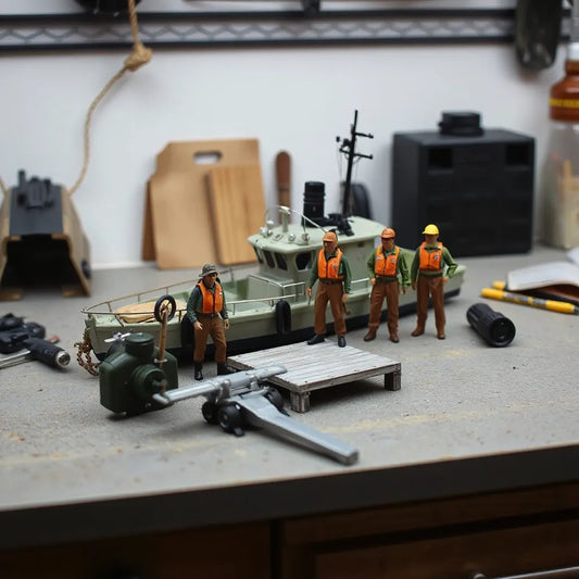 Detailed scale crew figures posed beside a miniature dock and small boat