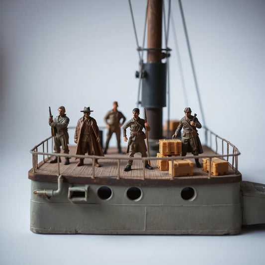 Detailed model figures posed on a ship deck diorama with railings and small accessories