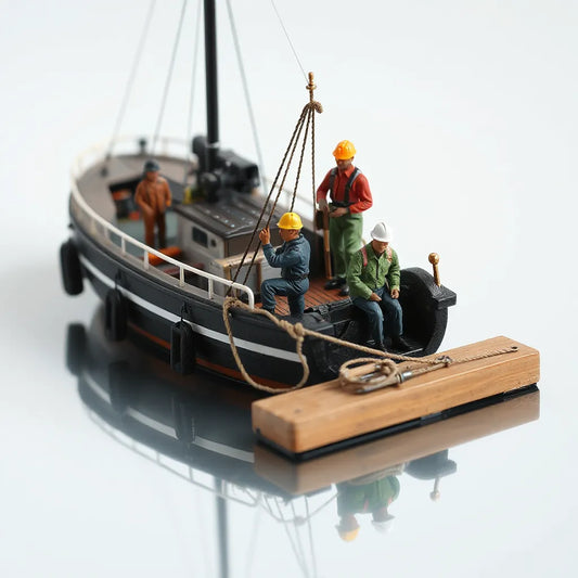 Scale model boat dock scene with crew figures posed on deck with small tools and ropes