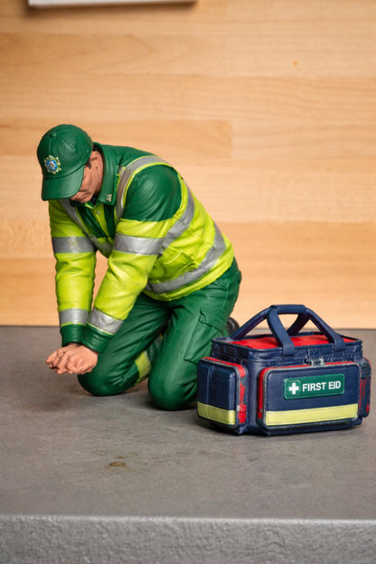 EMS28 Unpainted Figure: Male Paramedic Kneeling, Performing Chest Compressions